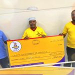 "Supa Loaf team presenting a Ksh 1 million donation cheque to support COVID-19 relief efforts in Mombasa County"